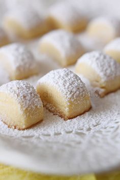 small pastries covered in powdered sugar on a table