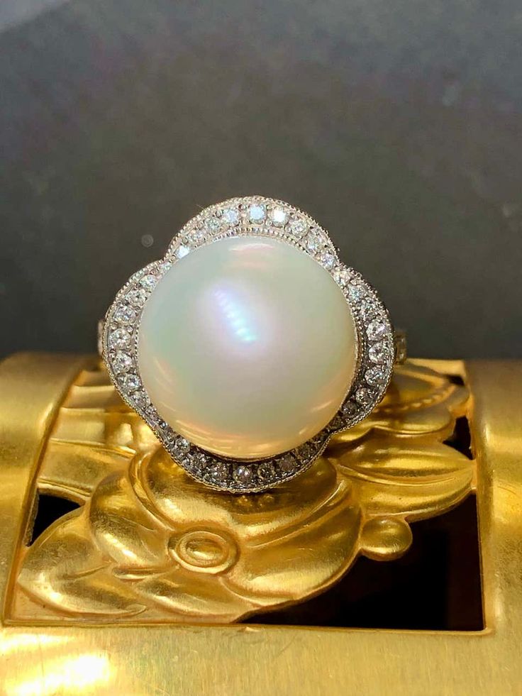 For Sale on 1stDibs - An elegant and timeless ring done in 18K white gold centered by a cream colored 13.4mm large South Sea pearl with very minor pitting and a beautiful, even Timeless White Gold Pearl Ring With Diamond Accents, Classic White Pearl Ring With Diamond Accents, Timeless Oval Rings With High Luster, Heirloom High Luster Oval Pearl Ring, White High Luster Heirloom Jewelry, White Heirloom Jewelry With High Luster, Heirloom White Jewelry With High Luster, Luxury Pearl White Pearl Ring With Diamond Accents, Luxury White Pear-shaped Diamond Ring