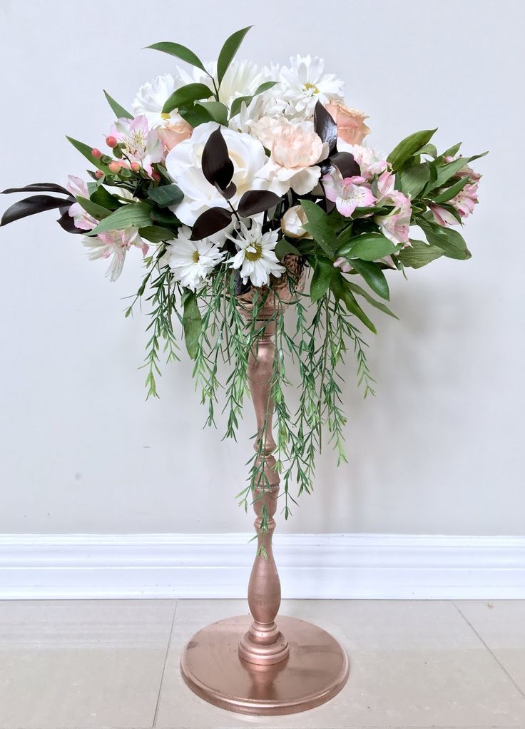 a vase filled with white and pink flowers