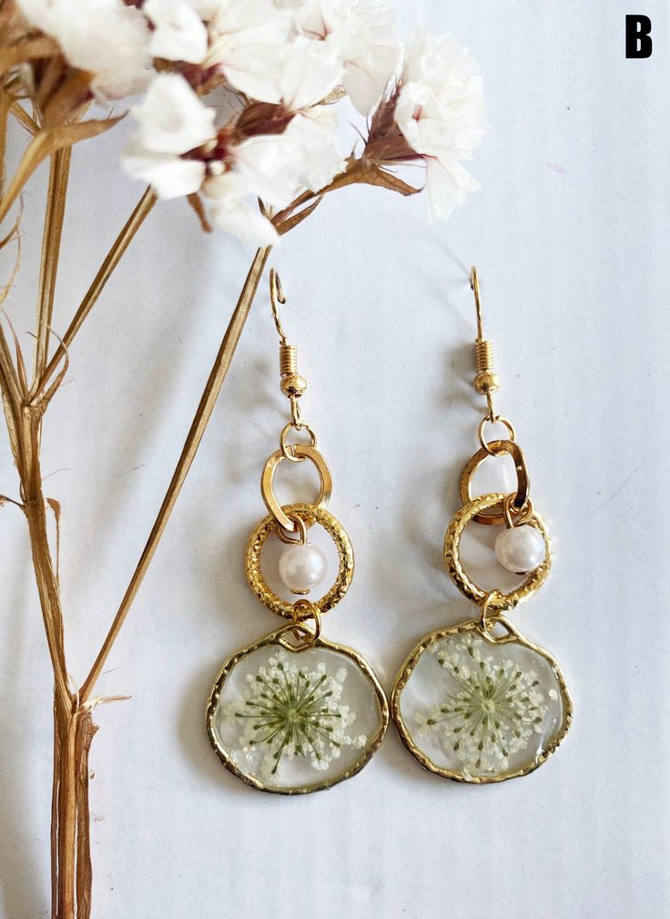 Handmade Earrings,  Hoop Earrings, Real Pressed Flower Earrings,Handmade Floral Earrings for Women, Birthday Gift, Cute Resin Earrings We choose the flowers near in the Como Lake Italy and we carefully select and preserve real flowers, allowing you to carry a piece of nature's splendor wherever you go.The gold-tone brass setting complements the intricate dries flowers, creating a captivating contrast that effortlessly adds a touch of sophistication to your ensemble. Total size: 2 cm X 5 cm The e Hoop Flower Charm Earrings As Gift, Handmade Nature-inspired Round Hoop Earrings, Handmade Flower-shaped Whimsical Jewelry, Nature-inspired Hoop Earrings As Gift, Handmade Delicate Flower Hoop Earrings, Nature-inspired Round Hoop Earrings For Gift, Whimsical Gold Flower-shaped Earrings, Handmade Hoop Flower Earrings For Gift, Small Hoop Jewelry With Flower Charm For Gifts