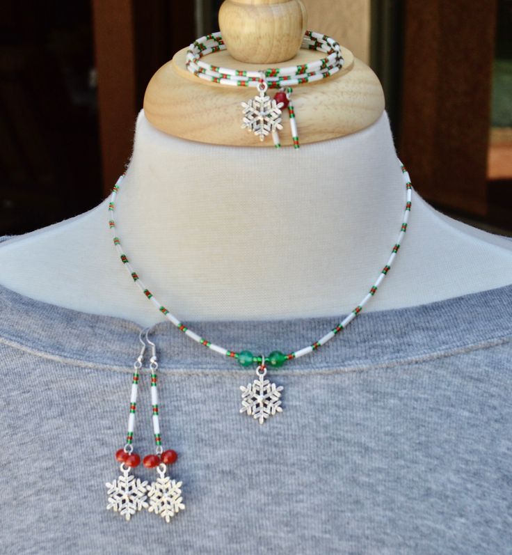 This is the ultimate Christmas jewelry set.  A necklace, earrings and a memory wire wrap bracelet.  They are made with white bugle beads, red and green sparkly 11/0 miyuki seed beads (beautiful) and red and green glass beads along with beautiful silver snowflake charms.  Such a pretty gift set.  Perfect for the upcoming Christmas season.  Everything is nickel free.  Message me if you have any questions. I usually ship in a white jewelry box but if you want a Christmas box just message me. This j Choker Necklace Handmade, Handmade Jewelry Set, Beaded Snowflake, Snowflake Bracelet, Snowflake Jewelry, Rare Beads, Jewelry Sets Handmade, Memory Wire Wrap Bracelets, Beaded Snowflakes