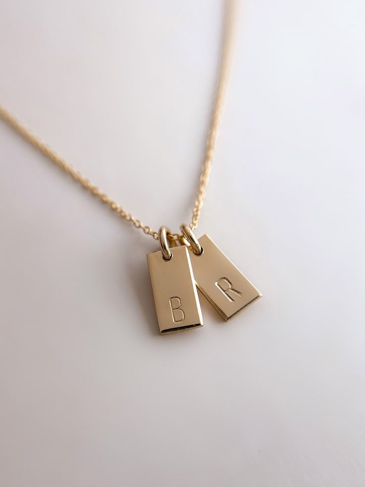 "Handmade Tiny Tag Necklace ✨   18k Gold Filled 💫 Hand Stamped Handstamped with the your choice of personalization with initials. 🌟  Handmade with 18k gold filled tiny tags on an 18k gold filled fully adjustable (up to 17.5\") dainty chain. Each individual letter is handstamped onto the gold filled tiny tags.  Hypo allergenic, lead free, nickel free.  Each piece is handmade in my home studio in Brookings, SD. Comes in Mandy Ellen Designs gift packaging with a polishing cloth included." Couple Necklace Aesthetic, Resizable Sterling Silver Jewelry For Gifts, Adjustable Personalized Yellow Gold Charm Necklaces, Adjustable 14k Gold Necklaces With Charms, Resizable Gold Jewelry As A Gift, 14k Gold Adjustable Jewelry Gift, Adjustable 14k Gold Filled Necklace For Anniversary, 14k Gold Adjustable Jewelry For Gifts, Minimalist Resizable Jewelry As Gift