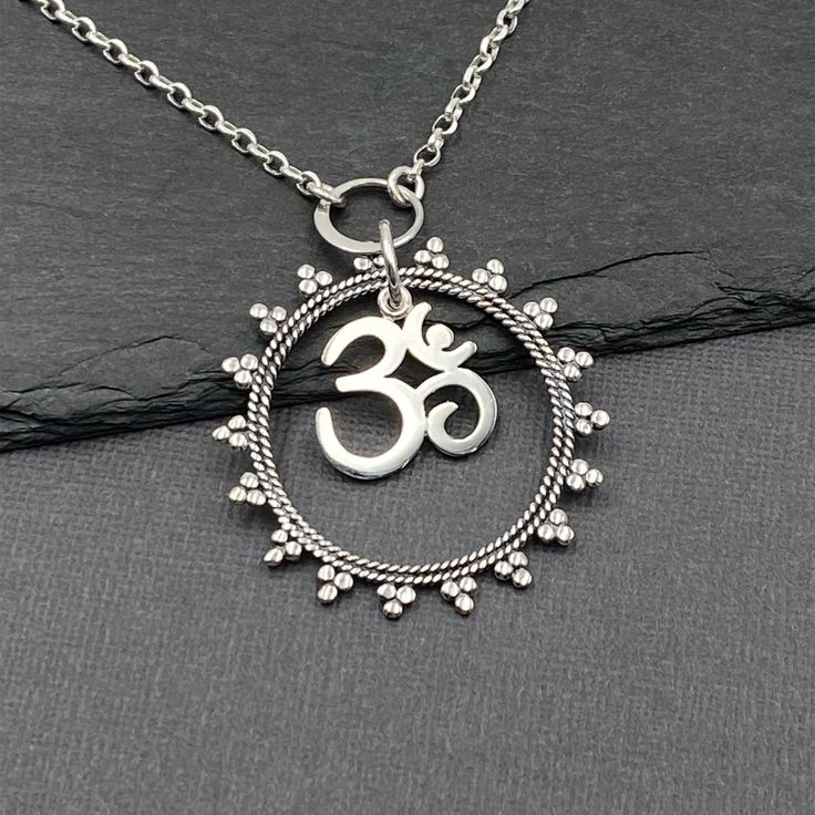 "Handmade Mandala Om Necklace is 925 solid sterling silver on an 925 solid sterling silver chain of your choice in style and length.  The Mandala pendant hold the Om charm that dangles freely.   Send a jewelry gift direct to your yoga bestie with a custom gift note! Om is a sacred sound that represents the union of the mind, body, and spirit that is at the heart of yoga. Ohm is a sacred syllable symbol of Hinduism and Buddhism and used in deep meditation. - Chain Styles:  Shiny Rolo or Oxidized Om Necklace Silver, Ohm Necklace, Ohm Pendant, Mandala Pendant, Om Necklace, Om Charm, Om Pendant, Yoga Necklace, Deep Meditation