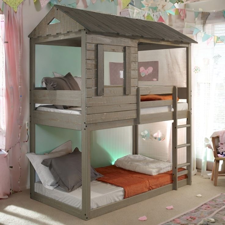 a child's bedroom with bunk beds and curtains