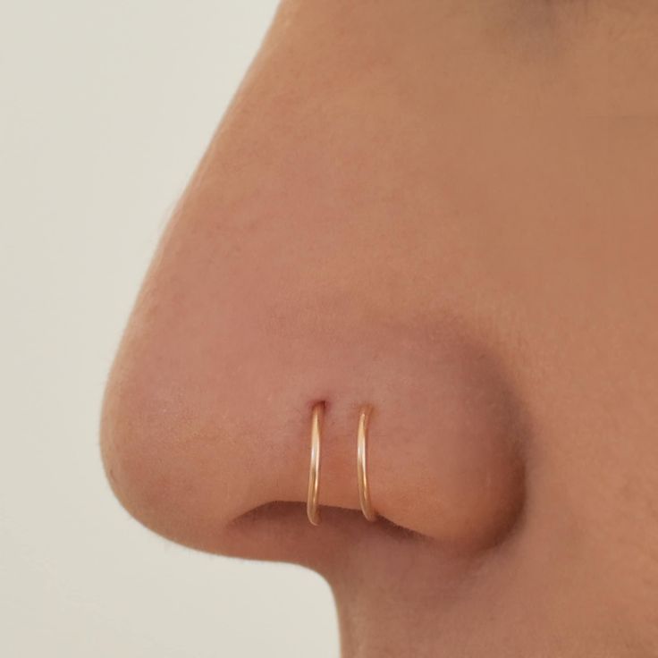 a close up view of a nose with an open nose ring on it's side