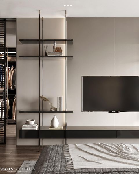 a living room with a large tv on the wall and shelves in front of it