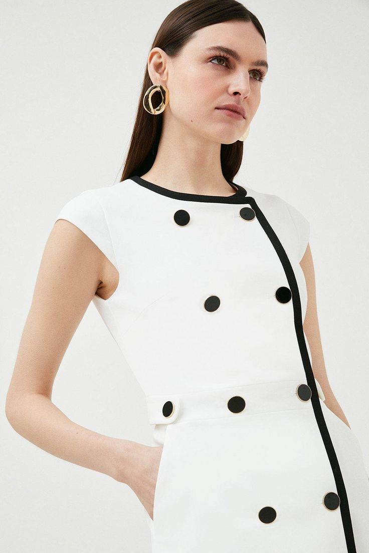 Enjoy An On-Trend 1960S Moment In This Retro Monochrome Dress. Defined By Its Neat Rows Of Contrasting Buttons And A Flattering A-Line Shape, This Sleek Design Is Perfect For Smart-Casual Spring Occasions And Features Handy Pockets For A Utilitarian Twist. Retro A-line Mini Dress For Work, Classic Button Back Dress For Work, Classic Dresses For Workwear With Button Back, Classic Workwear Dress With Button Back, Retro Mini Dress With Button Closure, Classic Dresses For Work With Button Back, Chic White Midi Dress With Button Cuffs, Retro Fitted Midi Dress With Buttons, Fitted Retro Midi Dress With Buttons