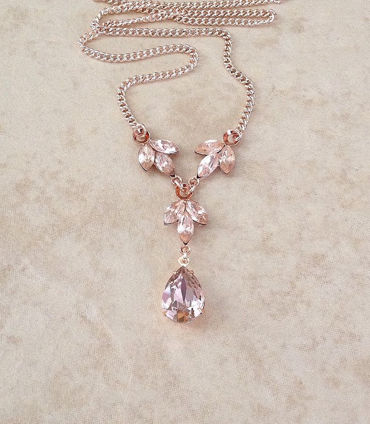 Gorgeous necklace done with a 14x10mm morganite pink teardrop crystal with 2 morganite pink crystal leaves. Rose gold metal finish. Beautiful necklace! 18 inches long. Thanks for stopping by! Feminine Rose Gold Necklaces For Weddings, Feminine Rose Gold Wedding Necklaces, Elegant Rose Gold Crystal Necklaces With Adjustable Chain, Pink Teardrop Pendant Necklace For Formal Occasions, Elegant Rose Gold Crystal Necklace With Adjustable Chain, Teardrop Lariat Necklace For Wedding, Elegant Pink Dangle Necklaces, Delicate Pink Drop Jewelry, Elegant Pink Drop Necklace For Gift