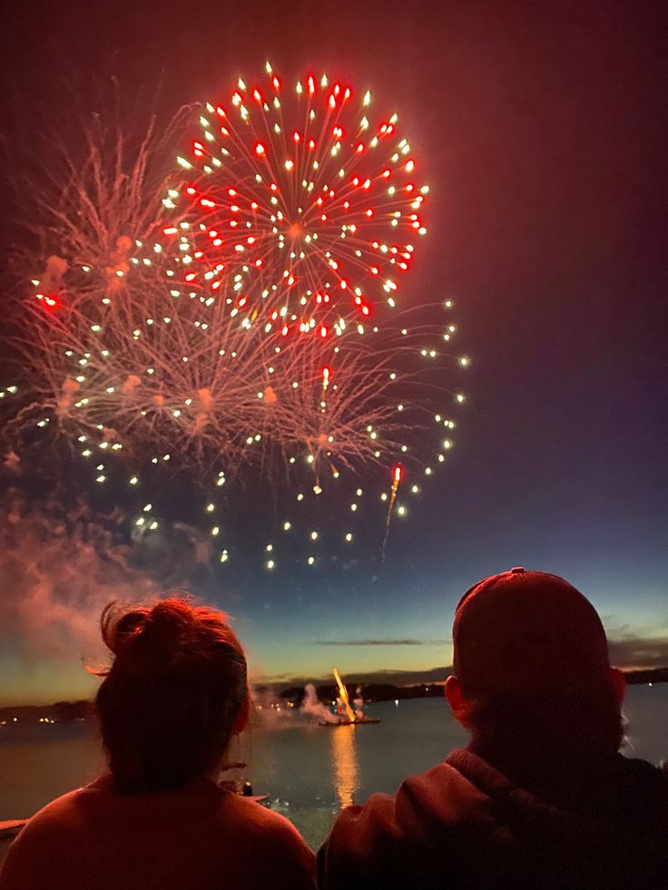 two people looking at fireworks in the sky