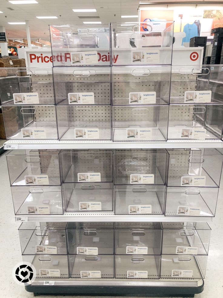 the display case is full of clear plastic boxes with price tags on them and labels for each item