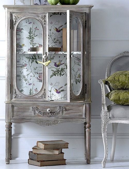 an old china cabinet is decorated with flowers and birds