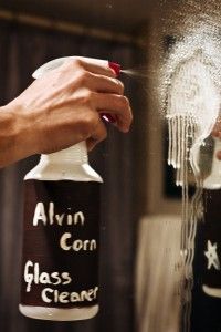 a person is spraying glass cleaner on their hair