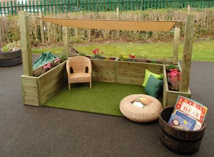 an outdoor seating area made out of wood and artificial grass