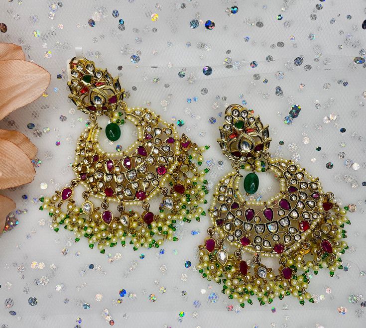 These gorgeous pair of earrings are made with 14k gold and is accented with high quality polki stones and pearls for the perfect statement look! The work is extremely beautiful with handcrafted stones and the colors are perfect to go with any outfit! Festive Jeweled Chandbali Pearl Earrings, Elegant Jeweled Earrings For Diwali, Elegant Jeweled Chandelier Earrings For Festive Occasions, Gold Jeweled Chandbali Pearl Earrings, Elegant Jeweled Chandbali Pearl Earrings, Elegant Multicolor Kundan Chandbalis, Jeweled Pearl Earrings For Festivals, Jeweled Pearl Earrings For Festive Occasions, Elegant Jeweled Danglers For Celebrations