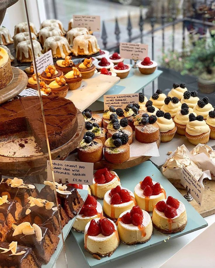 many different types of desserts are on display