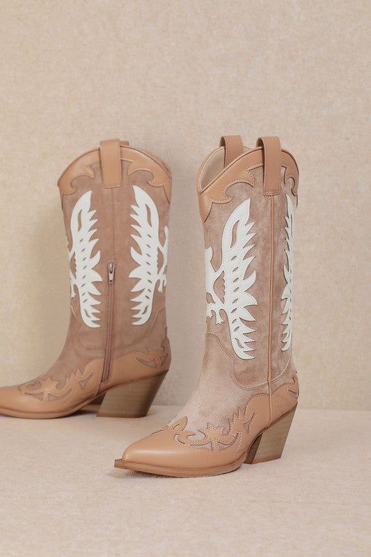 Embrace a feminine and flirty style at your next rodeo with the IDALY - Pastel Western Mid Boots. Crafted from smooth faux leather, these mid-calf boots are perfect for any festival scene, featuring a classic pointed-toe and intricate Western-inspired detailing in soft pink and beige hues. The curved topline with side pull tabs ensures easy on-and-off, while the wood-look stacked heel adds just the right amount of height. These boots combine charm and practicality, making them a must-have for th Trendy Leather Mid-calf Spring Boots, Western Knee-high Boots For Spring, Trendy Mid-calf Boots For Spring, Trendy Pointed Toe Mid-calf Boots For Spring, Spring Trendy Pointed Toe Mid-calf Boots, Spring Wide Calf Faux Leather Boots, Trendy Faux Leather Boots, Trendy Summer Faux Leather Boots, Knee-high Faux Leather Boots For Spring