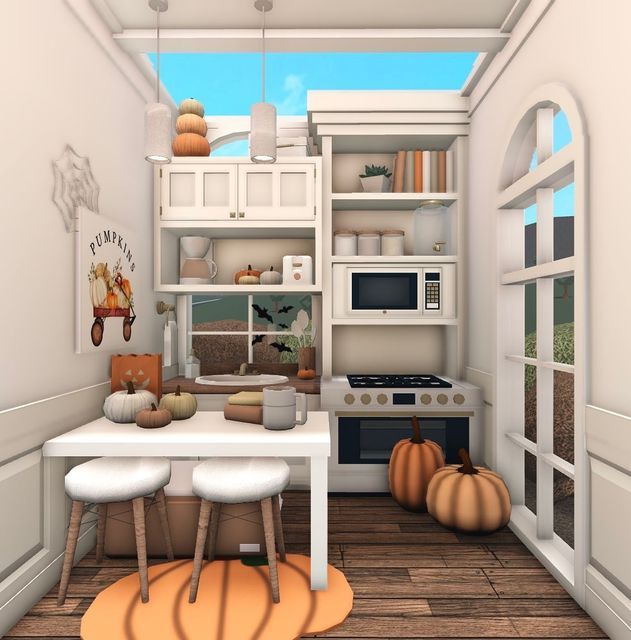 the kitchen is decorated in white and has pumpkins on the floor, as well as an oven