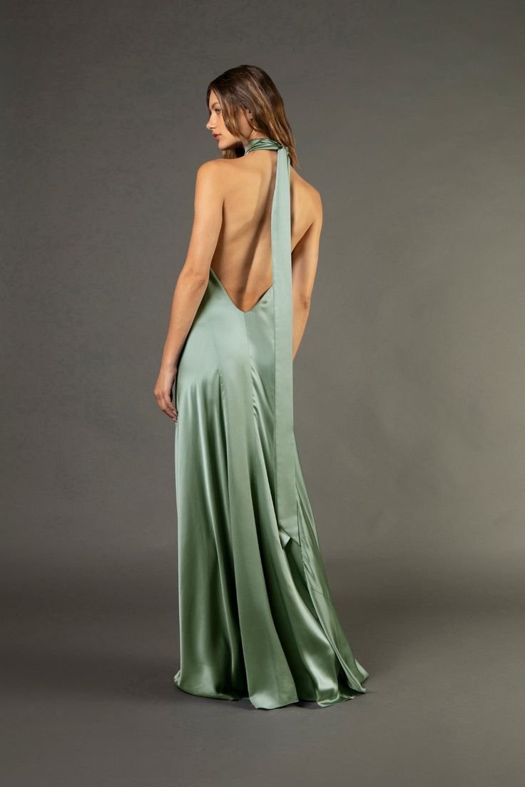 Pure silk charmeuse backless halter gown cut on the bias. Featuring a low open back and long ties at neck that can be double knotted or tied in a bow. Fully lined in silk. Made in USA. *Special orders in custom colors are also available. Please email us at shop@michellemason.com for further inquiries.   Composition: 10 Halter Neck Evening Dress With Keyhole Back, Fitted Satin Finish Halter Dress For Wedding, Floor-length Backless Dress With Fitted Bodice And Tie Back, Backless Dress With Bias Cut For Prom, Backless Bias Cut Dress For Prom, Backless Satin Halter Dress For Wedding, Elegant Halter Neck Maxi Dress With Keyhole Back, Chic Satin Gown With Back Opening, Gala Backless Dress With Tie Back And Fitted Bodice