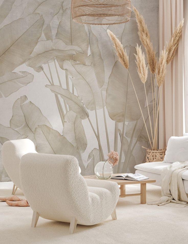 a living room with white furniture and large wall mural behind the chair is a coffee table