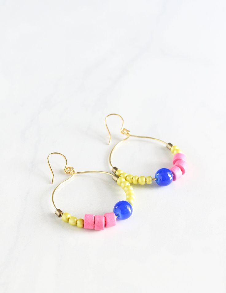 Jazz up your work attire with the colors of the tropics with these colorful, beaded earrings!  Dangling from a tarnish-free, gold-plated hoop, the terracotta, brass, and glass beads add a pop of color to your simple t-shirt or work outfit! OVERVIEW ❤︎ 1.5 inches in diameter ❤︎ Allow for 3 days for your item to be made ❤︎ This pair of fun, dangly earrings is perfect to gift your sister, mother, best friend ❤︎ Ready to be gifted, comes carefully gift-wrapped ❤︎ See all images on the listing ❤︎ All handmade by Amy Nieto of Little Bright Studio in Las Vegas, Nevada ☞ Contact me if you have any questions! https://www.etsy.com/conversations/new?with_id=11657624&referring_id=6090343&referring_type=shop&recipient_id=11657624 MEASUREMENTS & MATERIALS ￮ 1.5 inches long ￮ Gold-plated, tarnish-free wi Fun Gold Jewelry For Summer, Fun Gold Summer Jewelry, Summer Hoop Earrings With Ear Wire, Nickel-free Multicolor Earrings For Everyday Use, Everyday Multicolor Nickel Free Earrings, Everyday Multicolor Nickel-free Earrings, Nickel-free Small Hoop Earrings For Summer, Nickel Free Small Hoop Earrings For Summer, Summer Everyday Dangle Hoop Earrings