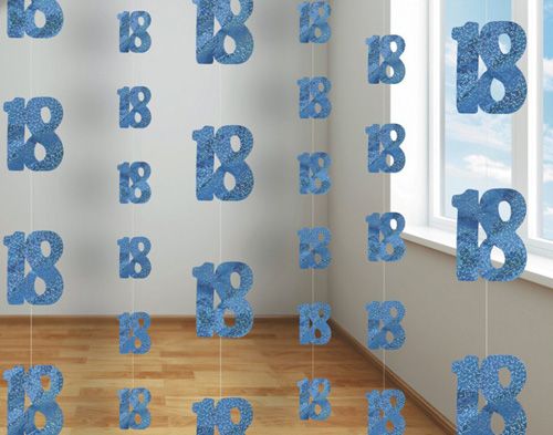 blue numbers hanging from strings in the shape of letters on a wall next to a window