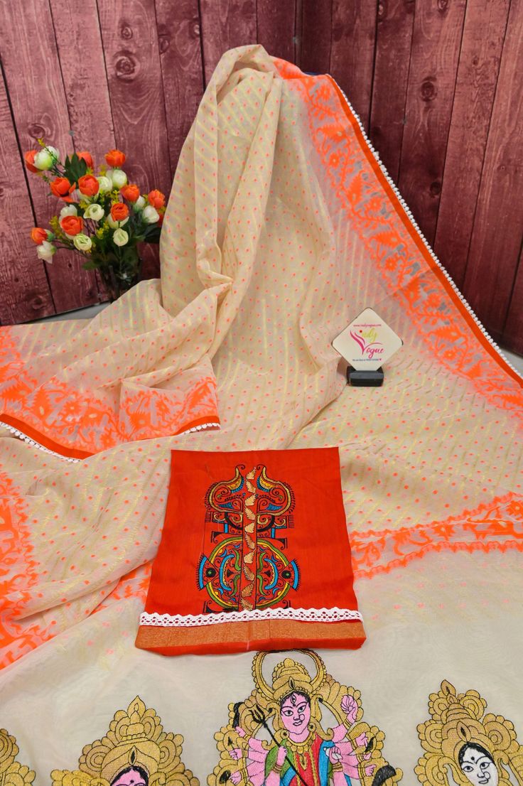 Now get ready with our latest designer jamdani collection with a pallu that comes with a machine-embroidered Durga family with lace work on the border. With all-over self-weaving work, this is a must-buy this puja season. Color: A shade of offwhite and orange color Technique: Comes with lace border and machine embroidered Durga family on the pallu Fabric: Cotton NOTE: Comes with a kalka (paisley) embroidered blouse piece White Anarkali Set In Mulmul, White Anarkali Mulmul Sets, White Mulmul Churidar For Festivals, White Blouse Piece With Resham Embroidery For Navratri, Festive White Mulmul Churidar, Festive White Mulmul Sets, Embroidered Georgette Sets For Puja, Georgette Churidar With Resham Embroidery For Traditional Ceremonies, Designer White Blouse Piece For Navratri