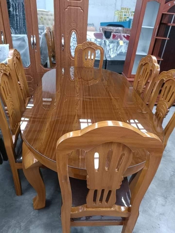 a wooden dining table and chairs in a room