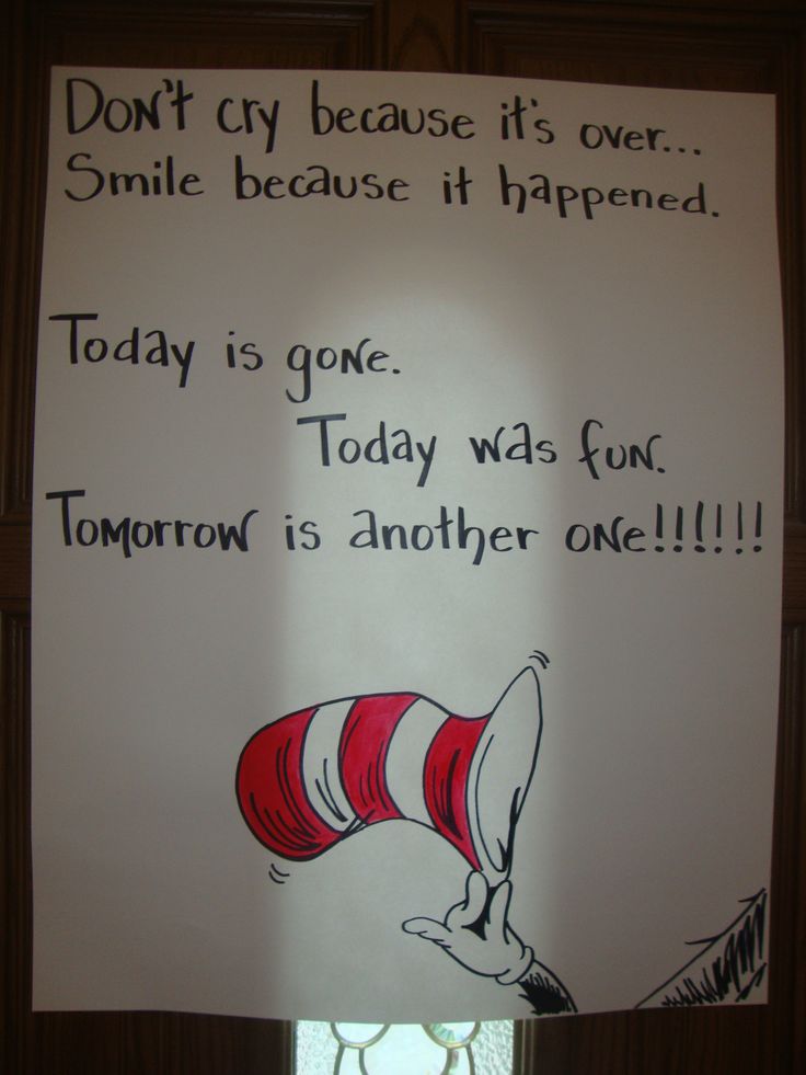 a dr seuss thing is hanging on the wall in front of a sign that says, don't cry because it's over smile because it's happened