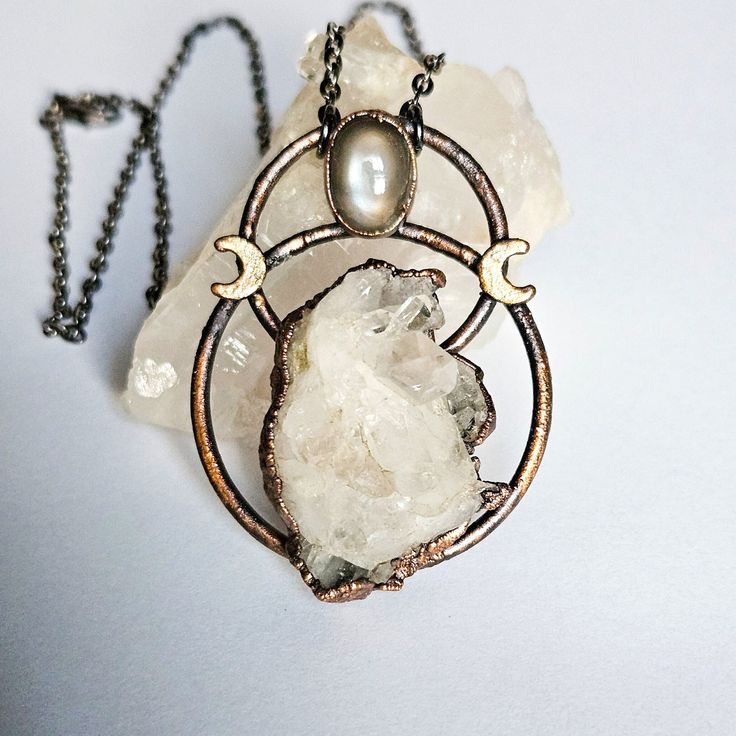 This is a clear quartz cluster necklace with a grey moonstone and crescent moon accent. The pendant was plated in a thick layer of copper then given an antique finish. The pendant height is approximately 2.5 inches with a 1.5 inch width. It hangs from a gunmetal chain in your choice on length. The pendant was hand shaped, polished, and sealed to prevent tarnishing. You will receiving the exact necklace pictured, it's ready to ship! Message me if you have any questions or if your interested in a Mystical Silver-plated Copper Necklace, Mystical Silver-color Copper Necklace, Mystical Silver-colored Copper Necklace, Grey Moonstone, Boho Statement Necklace, Crescent Moon Necklace, Cluster Necklace, Hand Shapes, Quartz Cluster