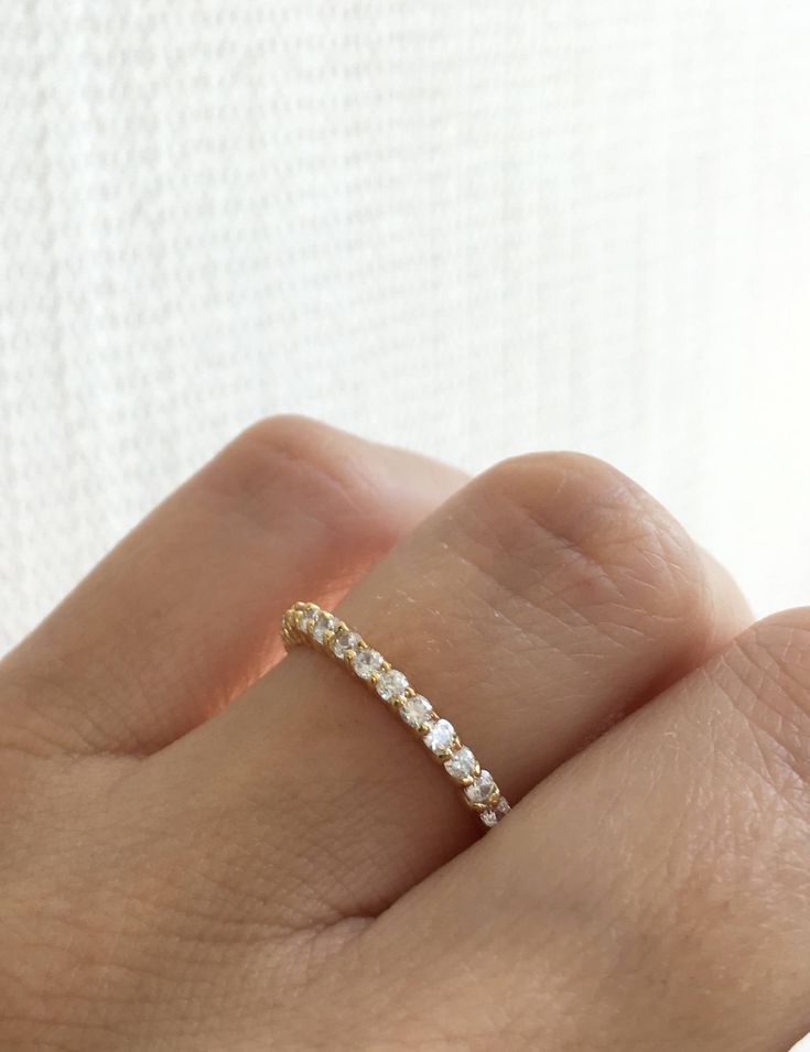 a woman's hand with a diamond ring on it