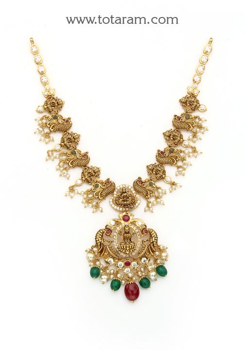 22 Karat Gold "Lakshmi - Peacock" Necklace With Cz, Color Stones, Pearls & Beads (Temple Jewellery)

 Experience Divine Beauty with our 22 Karat Gold "Lakshmi - Peacock" Necklace! Indulge in the exquisite craftsmanship of Indian jewelry with our stunning 22 Karat Gold "Lakshmi - Peacock" Necklace. Adorned with sparkling CZ, colorful stones, lustrous pearls, and delicate beads, this piece exudes timeless elegance and charm. The intricate design featuring a divine Lakshmi motif and a majestic peac Elegant Kundan Temple Necklace With Peacock Design, Gold Temple Jewelry Necklaces For Designer Wear, Designer Temple Necklace For Festivals, Traditional Necklaces With Intricate Design For Designer Wear, Festive Designer Temple Necklace, Festive Kundan Temple Necklace With Peacock Design, Designer Gold Necklace With Intricate Design, Gold Necklace With Intricate Design For Designer Wear, Temple Jewelry Necklace For Diwali Designer Wear