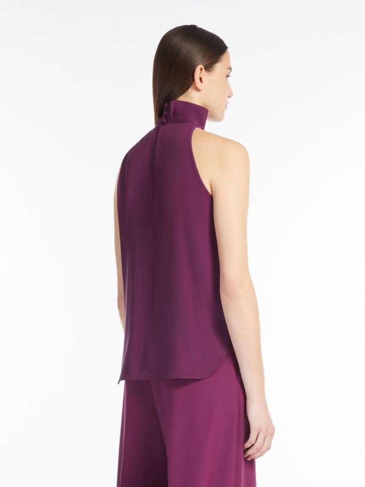 Find MAX MARA American Silk Top on Editorialist. Sleeveless top with halter neck, made of exquisite pure silk charmeuse. Unlined garment with a flowing line, featuring a soft pleated pattern on the front, high collar and small rounded side slits. Teardrop closure at the back with covered buttons at the rear of the collar. Sleeveless Satin Halter Top For Formal Occasions, Satin Sleeveless Halter Top For Formal Events, Chic Silk Halter Top For Formal Occasions, Chic Silk Halter Top For Formal Events, Chic Formal Silk Halter Top, Elegant Halter Neck Tank Top For Evening, Formal Satin Sleeveless Halter Top, Elegant Silk Halter Top For Party, Elegant Silk Halter Top For Formal Occasions