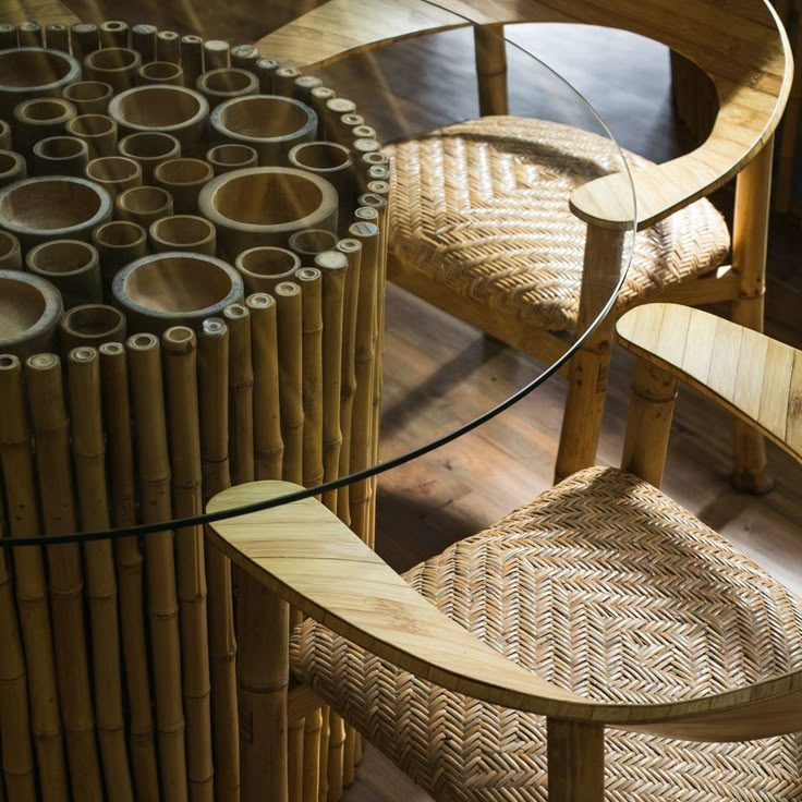 a bamboo table with two chairs next to it