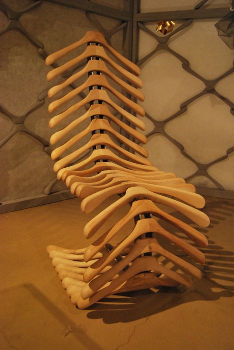 a stack of wooden planks sitting on top of a floor next to a chain link fence