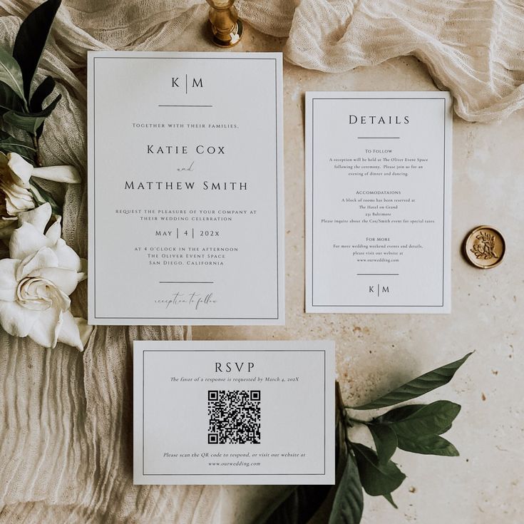 the wedding stationery is laid out on a table with flowers and greenery next to it