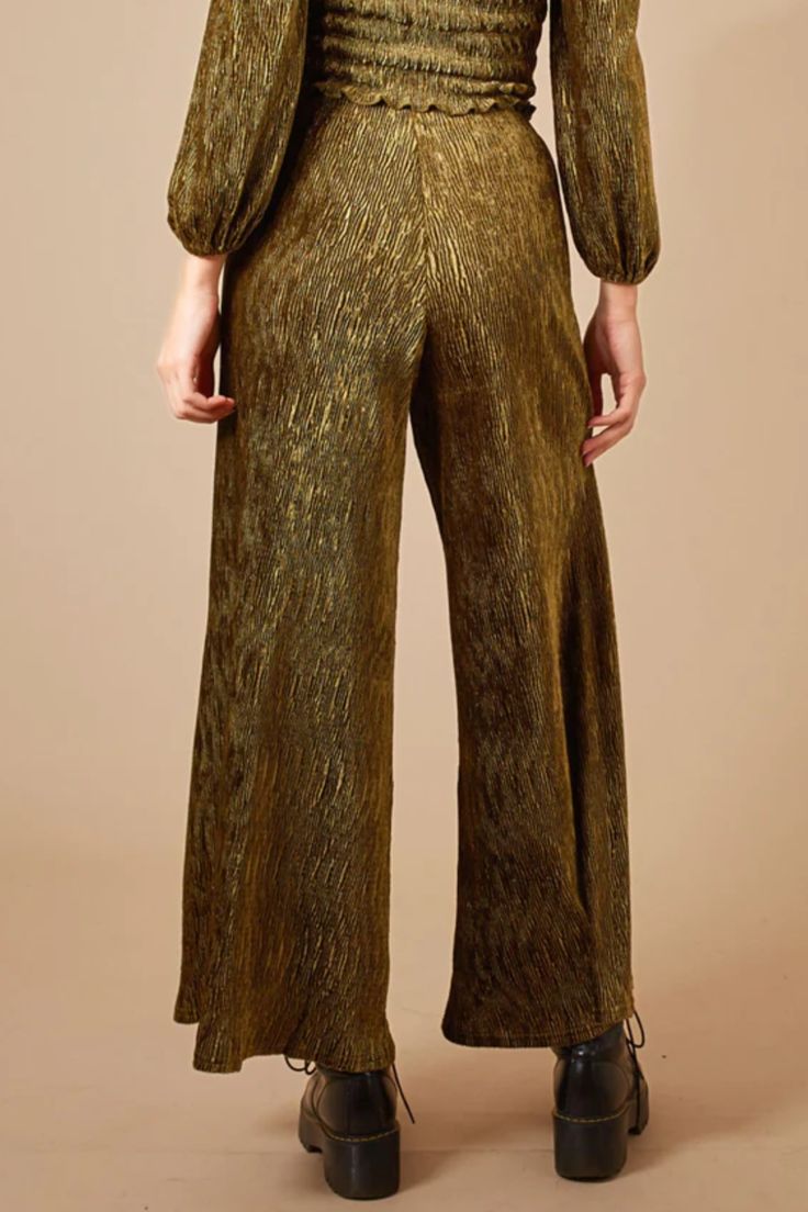 Elevate your winter wardrobe with these stunning palazzo pants. Crafted from our exquisite Wading In The Velvet Sea fabric, they feature a flattering silhouette and a touch of metallic shimmer. These pants are both comfortable and stylish, making them the perfect choice for any special occasion. Elegant Gold Evening Bottoms, Festive Wide Leg Bottoms For Night Out, Festive Wide Leg Pants For Evening, Wide Leg Pants For Evening And Festive Occasions, Festive Wide Leg Pants For Party, Festive Wide Leg Party Pants, Formal Metallic Wide Leg Bottoms, Chic Festive Pants, Glamorous Wide Leg Bottoms For Festive Occasions