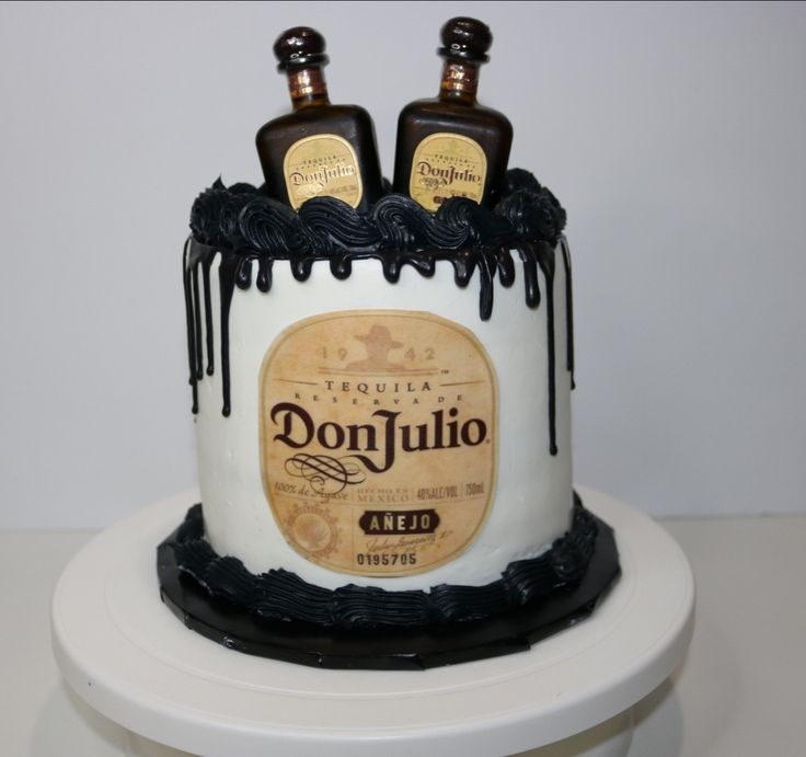 two bottles of donjullo on top of a white cake with chocolate icing