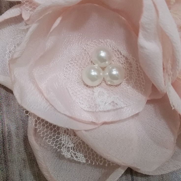 This fancy dress is made with layers of blush pink and a touch of light peach colored tulle. I only use premium 100% nylon tulle to ensure the best quality on every dress. The tulle is attached to a grey crochet top. Three beautifully embellished blush pink flowers adorn the top. The flowers also have a touch of lace and faux flowers which make them very unique and beautiful. I am open to customizing the flower style to match your wedding, please message me to discuss. Blush pink ribbon flows do Elegant Spring Tutu Dress, Delicate Pink Party Dresses, Elegant Beige Tulle Fabric For Party, Elegant Pink Tulle Fabric With Ruffles, Elegant Pink Ruffled Tulle Fabric, Elegant Pink Tutu Dress For Wedding, Elegant Cream Tutu Dress For Wedding, Elegant Pink Tulle Fabric For Spring, Pink Tulle Tutu Dress For Wedding