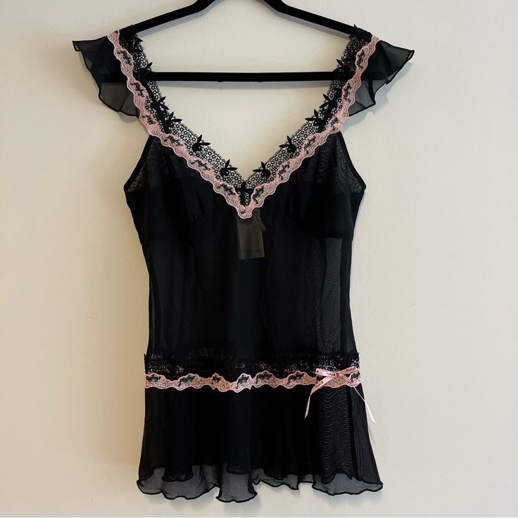 This Is The Coolest Little Tank Ever! Sheer Black With Pink Trim, And Lined With Lace Bunnies. It Even Has "Playboy" Embroidered In, And A Little Pink Bow On The Bottom. Ruffled Sleeves And Hem Just To Top It All Off. Brand New With Tags! All Measurements Are Approximate And Taken With The Item Laid Flat. Chest: 16" Hips: 17" Length: 25" Sleeve: 3" Waist: 14.5" Feminine Fitted Black Sleepwear, Fitted Black Feminine Sleepwear, Fitted Feminine Black Sleepwear, Pink Camisole Top With Coquette Style, Pink Coquette Camisole Top, Coquette Pink Top For Party, Black Feminine Camisole For Party, Pink Fitted Camisole For Night, Pink Lace Trim Top For Night Out