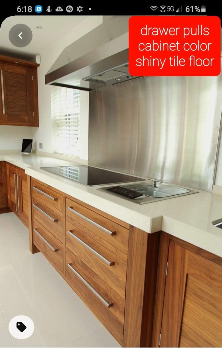 a modern kitchen with wooden cabinets and stainless steel range hood over the stove top oven