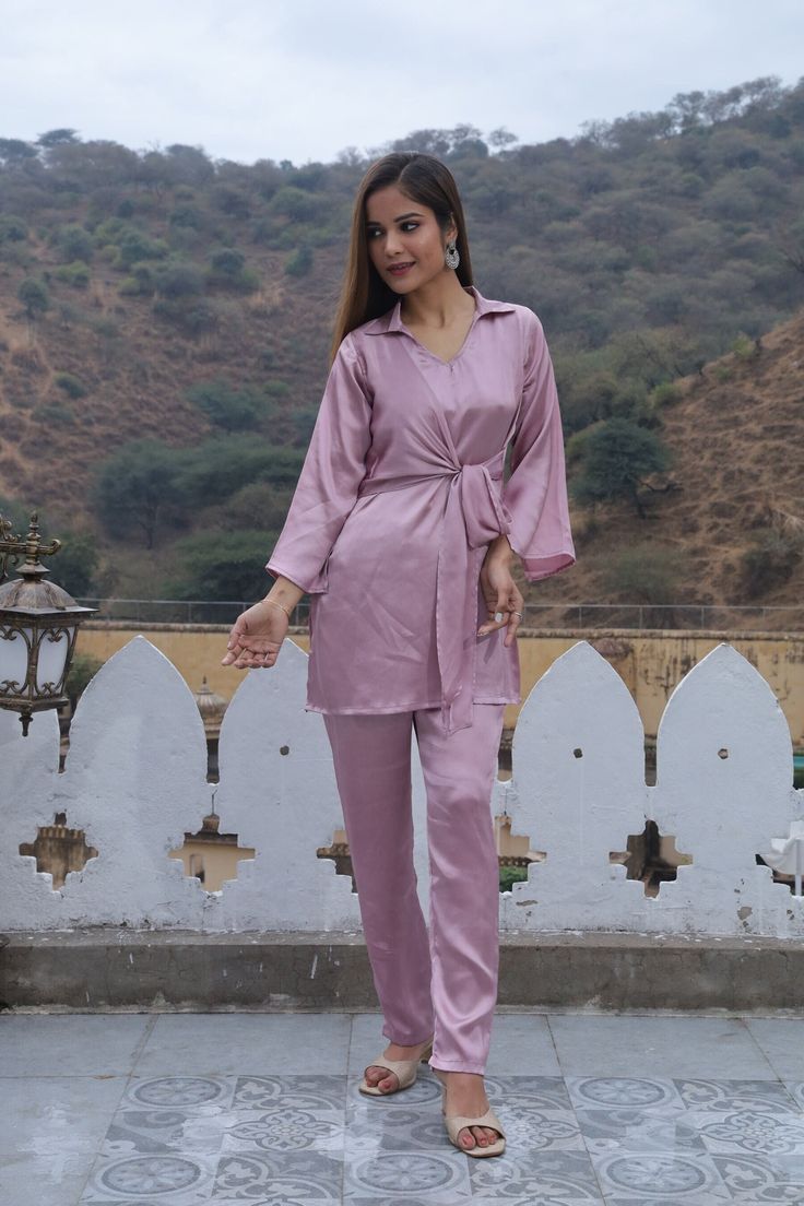 Description :- Fabric. - satin silk  Color - Dusky pink  Neck line - V- neckline with collar  Contain - Top and Trouser. Made from lightweight breathable fabric. sizes available UK/ US - 8 , 10, 12, 14, 16, 18  Introducing our "In Full Bloom " co-Ord set, made from luxurious satin silk fabric in a lovely Dusky Pink hue. This stylish set features a V-neckline with a collar, adding an elegant touch to your look. The set includes a charming top and comfortable trousers. Get ready to elevate your st Elegant V-neck Sets For Wedding Night, Silk V-neck Party Sets, Elegant Satin V-neck Sets, Pink Satin Sets For Wedding Night, Feminine Pink Sets For Wedding Night, Pink V-neck Wedding Sets, Long Sleeve Sets For Bridesmaids, Pink Feminine V-neck Set, Feminine Pink V-neck Set