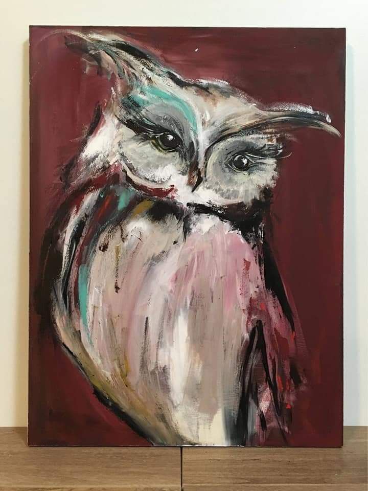 an owl painting is displayed on a shelf in front of a white wall and red background