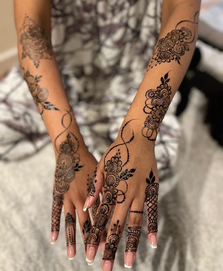 a woman with henna tattoos on her hands