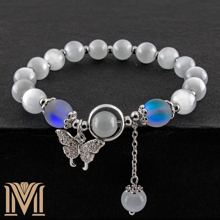 Check out our other designs from the link below: https://www.etsy.com/ca/shop/marvelousnobleart Fits wrists from 5.5 to 7 inches (14 to 18 cm) Enhance your jewelry collection with this stunning moonstone cat's eye bracelet, crafted with exquisite attention to detail. This elegant piece features lustrous moonstone cat's eye beads that shimmer with a mesmerizing play of light, creating a captivating look perfect for any occasion. Adorned with a charming butterfly pendant embellished with sparkling Cat Eye Bracelet, Moonstone Bracelet, Crystal Embellishment, Butterfly Pendant, Sparkling Crystal, Ideal Gift, Moonstone, Gifts For Women, Jewelry Collection