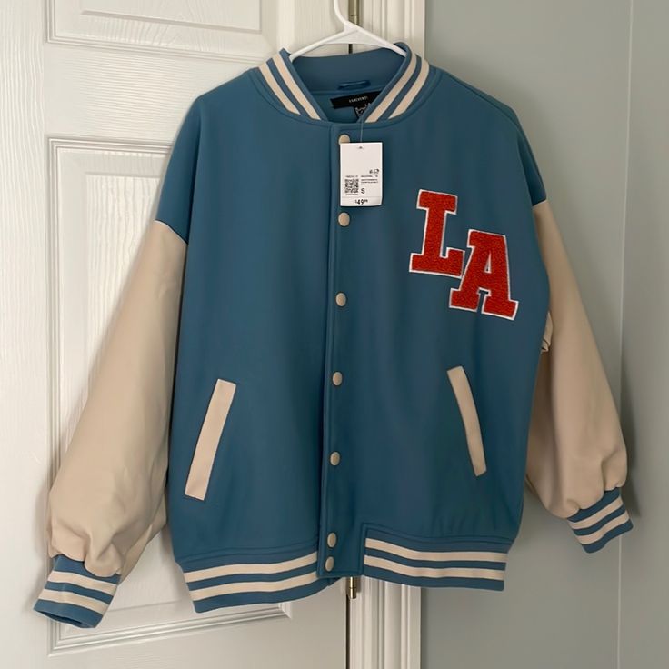 Brand New With Tags La Varsity Jacket. Forever 21 Spring Varsity Outerwear For College, Varsity Outerwear For College In Spring, Trendy Blue Varsity Jacket For Streetwear, Trendy Oversized Varsity Jacket For Spring, Trendy Blue College Varsity Jacket, Oversized Varsity Jacket For Spring, Trendy Oversized Varsity Jacket For Fall, Blue College Style Outerwear For Streetwear, Oversized Spring Outerwear For College