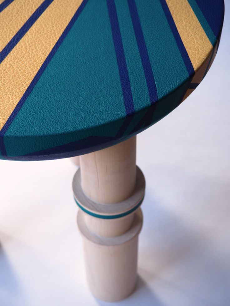 a close up of a table with a blue and yellow umbrella on it