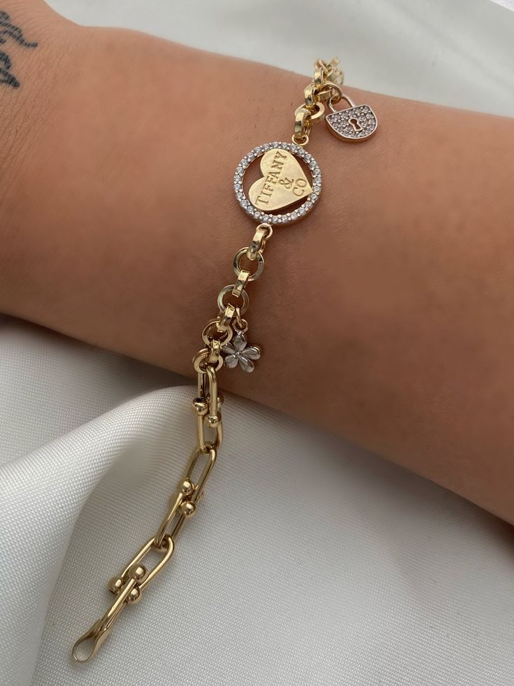 ITEM DETAILS ❆All our jewelry are hand made with Love. ❆Material: 14K Gold ( 585). ❆Available colors: Gold, Rose Gold, White Gold. ❆Available Sizes: Look Size Option (Contact for different sizes) ❆Each item is made to order ❆ DO YOU LIKE THIS BRACELET? ❆ You can get more information about it below but if you have any questions, just click the "Message Sergen Vural " button and I will be very happy to hear from you ☺ PACKAGING ❆Comes ready to gift in a beautiful jewelry box. ❆It comes with a special certificate in your name. PROCESSING & SHIPPING ❆Free express shipping worldwide ❆Your order will be handmade and ready for shipment in 2-3 business days. ❆We ship jewelry with guaranteed and insurance transport companies in 3-4 business day. PIN IT on PINTEREST - @miladescom FOLLOW on Instagram Luxury White Gold Charm Bracelet For Women, Luxury Logo Charm Bracelet For Gift, Luxury Gold Bracelet With Dangling Charms, Luxury Gold Round Charm Bracelet, Metal Charm Bracelet With Heart Charm For Mother's Day, Valentine's Day Gift Chain Bracelet With Lobster Clasp, Valentine's Day Chain Bracelet Jewelry, Mother's Day Metal Charm Bracelet With Heart Charm, Mother’s Day Metal Charm Bracelet With Heart Charm