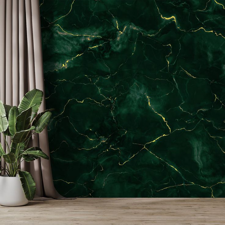 a green marbled wall with a plant in the corner