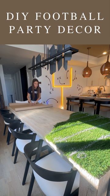 a woman sitting at a table with green grass on it and the words diy football party decor