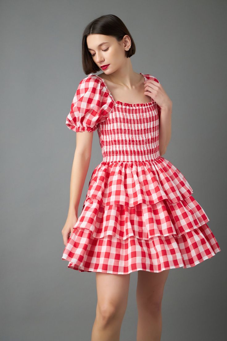 Looking for a playful and flattering dress? Our Gingham Mini Dress is perfect for any occasion! The gingham print is both timeless and chic, while the smocked detail and puff sleeves add a touch of whimsy. The lined bodice ensures a comfortable and flattering fit, while the mini length is perfect for showing off your legs! Whether you're headed to a picnic or a summer party, this dress is sure to turn heads! Gingham print Lined Puff sleeves Smocked detail Shell; 85% Cotton 15% Tencel Lining; 100% Cotton TL432D Total length: 35" Bust: 31.50" S Height 5'9" / Bust 32" / Waist 24" / Hip 35" Plaid Square Neck Dress For Garden Party, Square Neck Plaid Dress For Garden Party, Square Neck Dress With Ruffle Hem For Picnic, Gingham Short Sleeve Dress With Smocked Bodice, Short Sleeve Gingham Smocked Dress, Gingham Dress With Smocked Bodice And Short Sleeves, Short Sleeve Gingham Dress With Smocked Bodice, Gingham Dress With Ruffle Hem And Square Neck, Puff Sleeve Dress With Ruffle Hem For Picnic